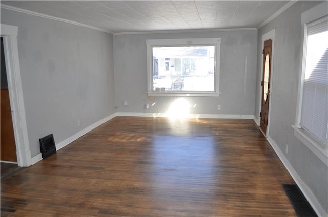 unfurnished room featuring ornamental molding, plenty of natural light, and dark hardwood / wood-style floors