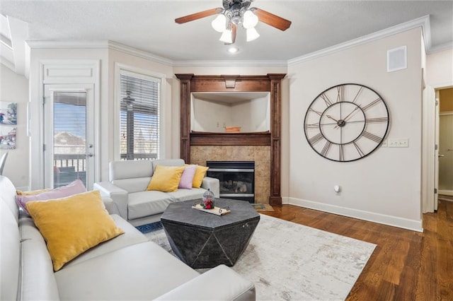 living area featuring ornamental molding, visible vents, dark wood finished floors, and baseboards