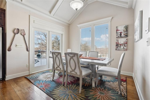 dining room with vaulted ceiling, dark wood-style flooring, and plenty of natural light