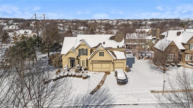 snowy aerial view featuring a residential view