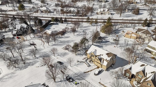 snowy aerial view featuring a residential view