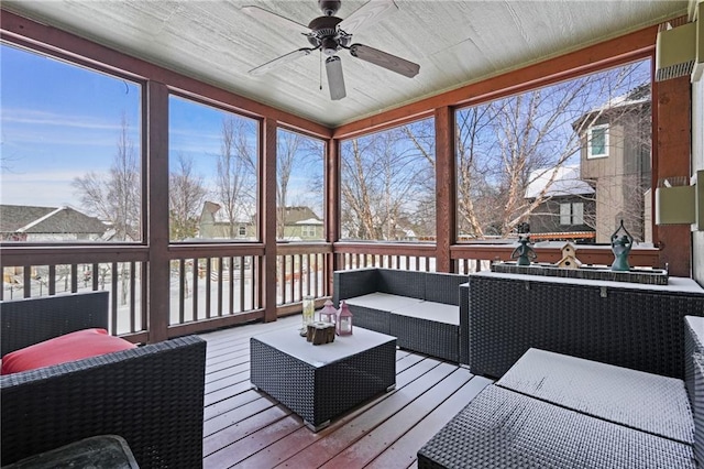 sunroom / solarium with a ceiling fan