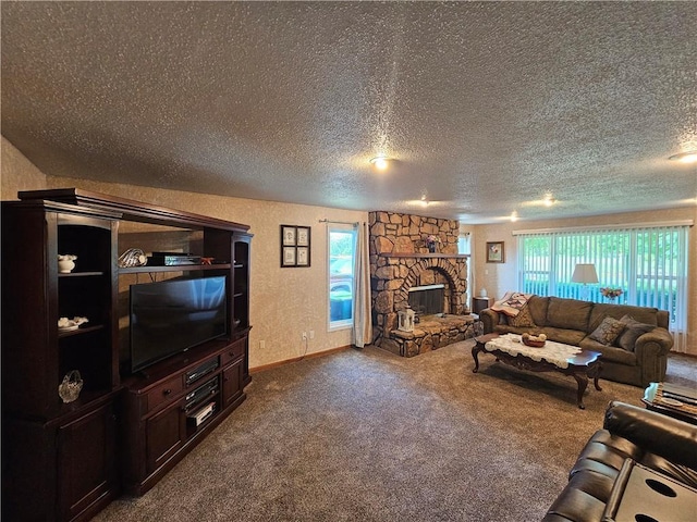 carpeted living room with a fireplace and a textured ceiling