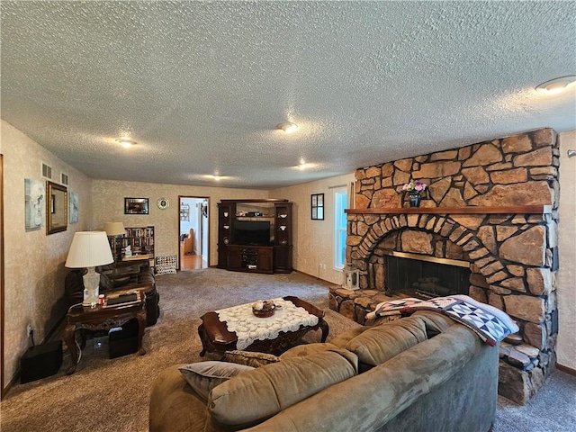 carpeted living room with a stone fireplace and a textured ceiling