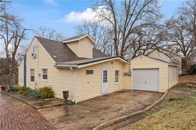 view of side of home with cooling unit and a garage