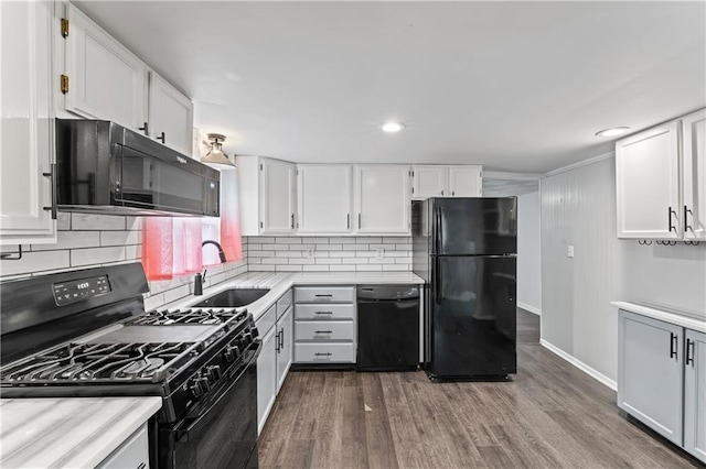 kitchen featuring white cabinetry, sink, hardwood / wood-style floors, and black appliances