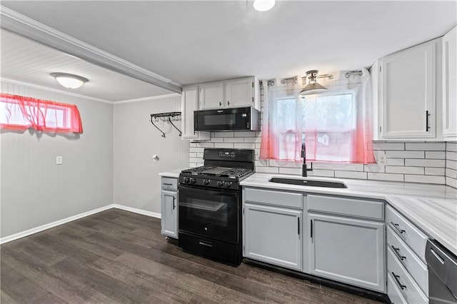 kitchen with sink, black appliances, dark hardwood / wood-style floors, decorative backsplash, and white cabinets