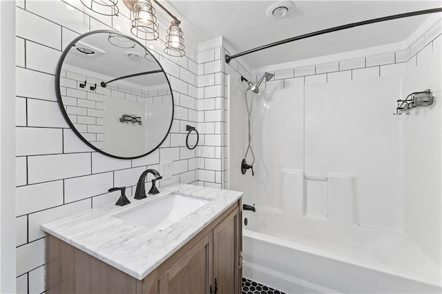 bathroom with vanity, decorative backsplash, tile walls, and washtub / shower combination