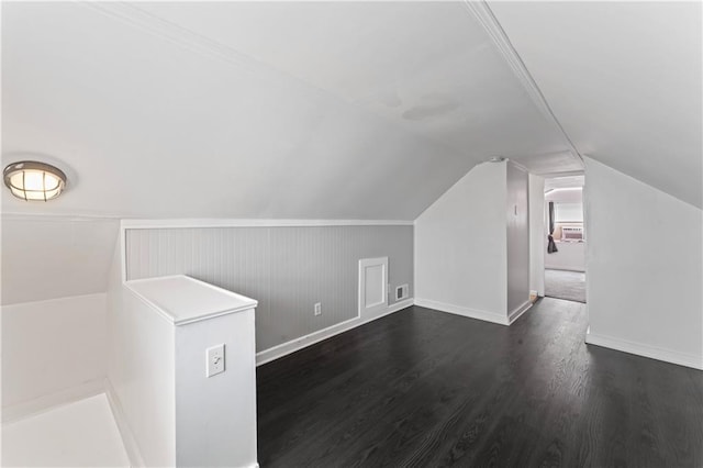 additional living space featuring dark hardwood / wood-style flooring and vaulted ceiling