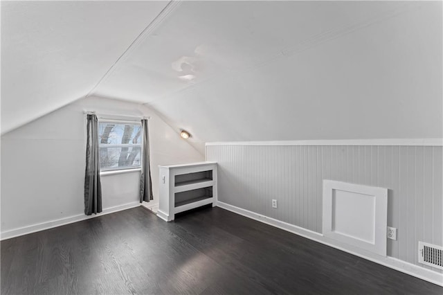 bonus room featuring dark wood-type flooring and lofted ceiling