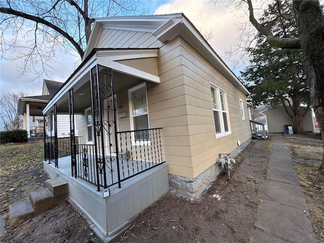 property exterior at dusk with a porch