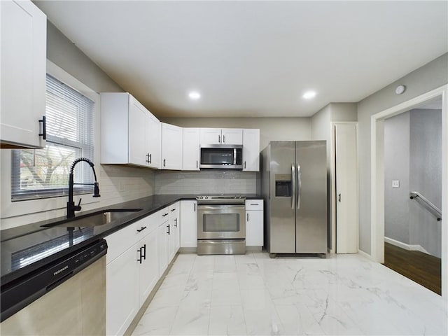 kitchen with white cabinetry, appliances with stainless steel finishes, and sink