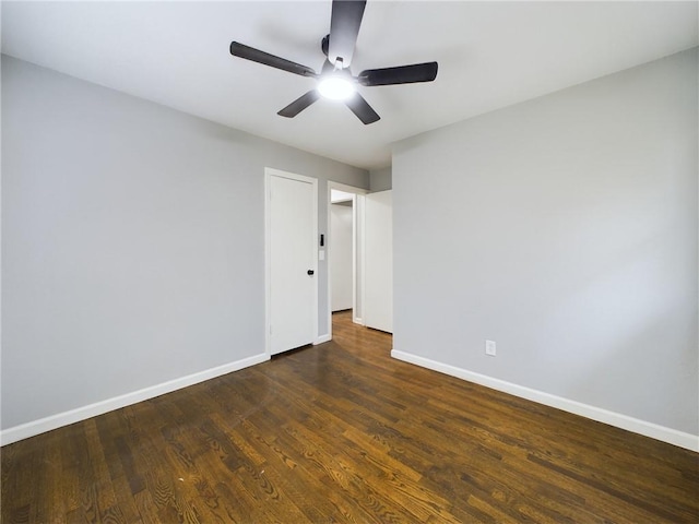 spare room featuring ceiling fan and dark hardwood / wood-style floors