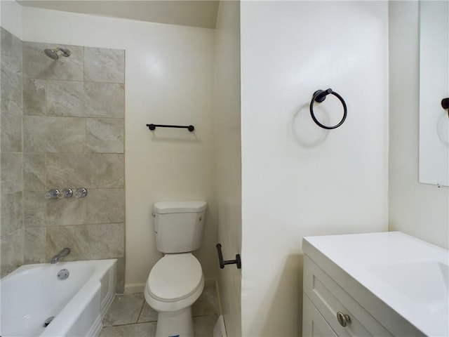 full bathroom featuring tile patterned flooring, vanity, tiled shower / bath, and toilet