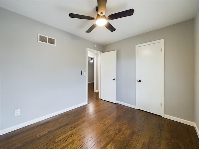 unfurnished bedroom featuring ceiling fan and dark hardwood / wood-style floors