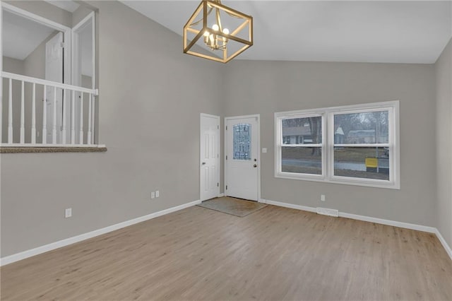 entryway with a chandelier and light hardwood / wood-style flooring