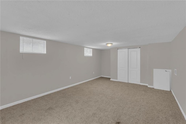 basement with carpet floors and a textured ceiling