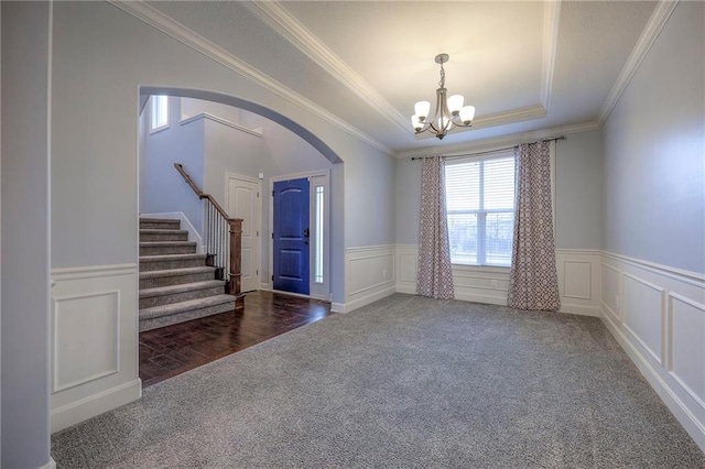 interior space featuring crown molding, a notable chandelier, and a tray ceiling