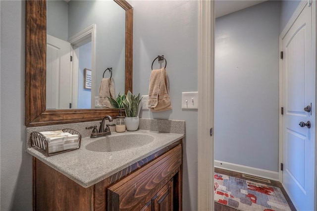 bathroom featuring baseboards and vanity