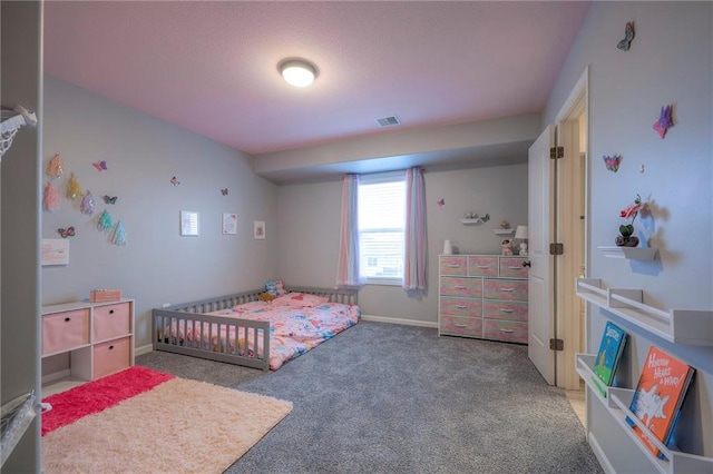 bedroom with dark colored carpet, visible vents, and baseboards