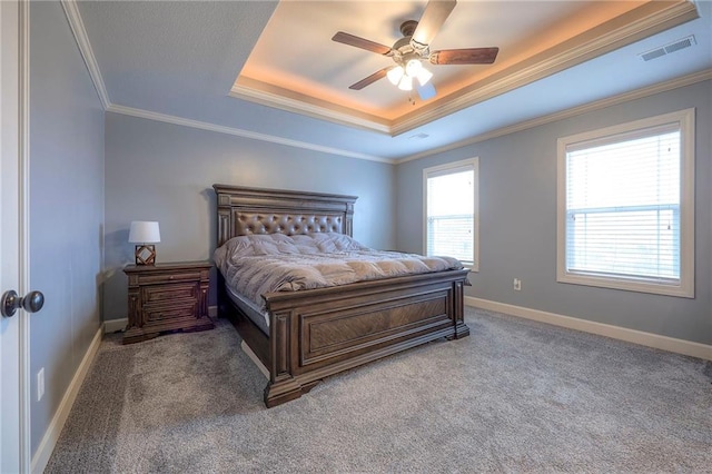 carpeted bedroom with crown molding, a raised ceiling, and ceiling fan