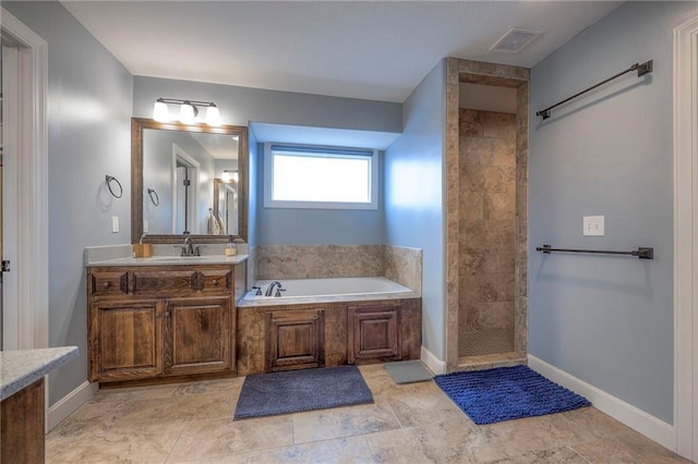 bathroom featuring visible vents, vanity, a walk in shower, baseboards, and a bath