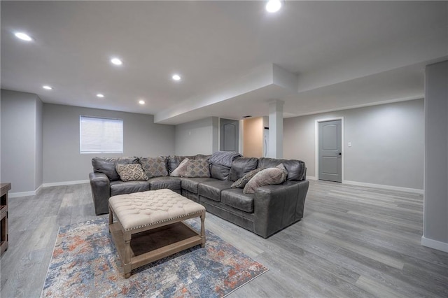 living room featuring baseboards, recessed lighting, and light wood-style floors