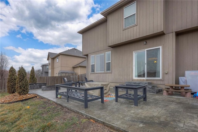 back of house with a fire pit, a patio, and fence