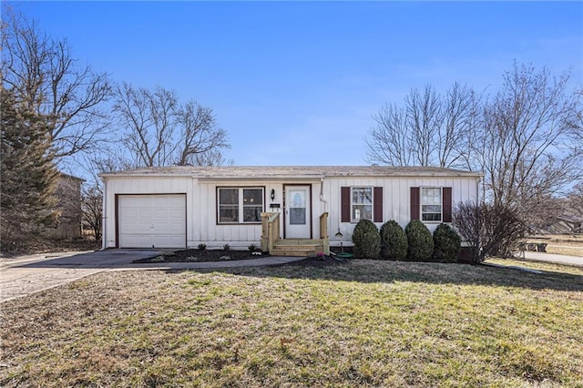 view of front of home with driveway, a front yard, board and batten siding, and an attached garage