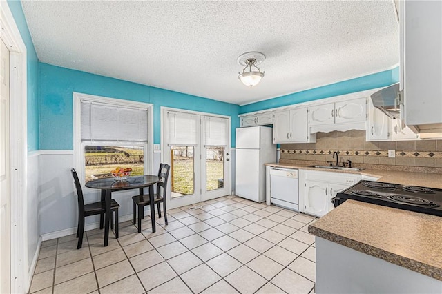 kitchen with white cabinets, white appliances, a textured ceiling, wall chimney exhaust hood, and a sink