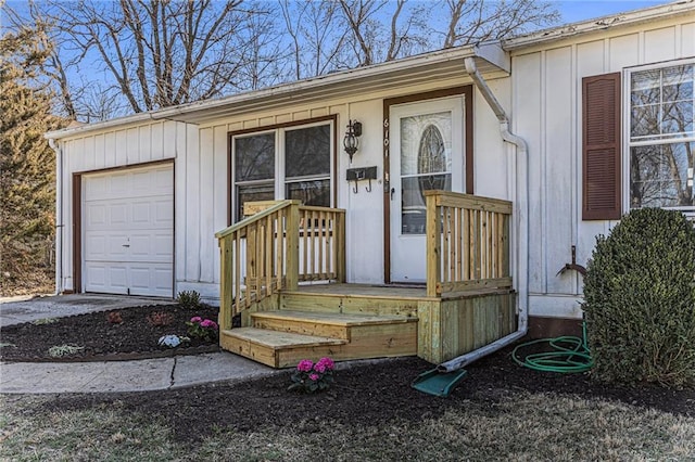 property entrance featuring a garage and board and batten siding