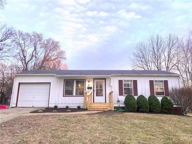 ranch-style house with board and batten siding, concrete driveway, a garage, and a front yard