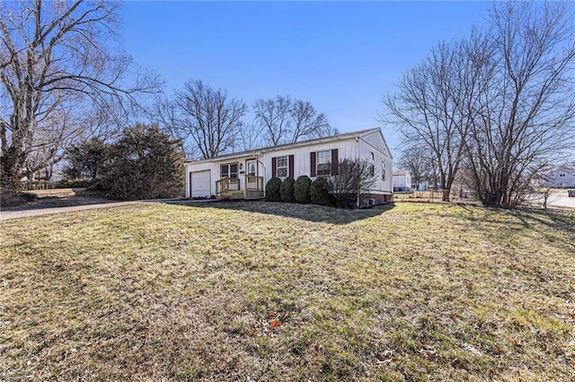 view of front of house with an attached garage and a front yard