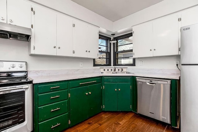 kitchen featuring under cabinet range hood, a sink, white cabinetry, light countertops, and appliances with stainless steel finishes