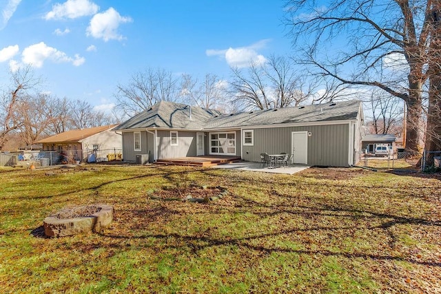 rear view of house featuring a patio area, fence, and a lawn