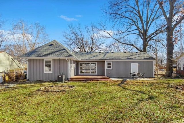 rear view of house featuring cooling unit, fence, a lawn, and a patio