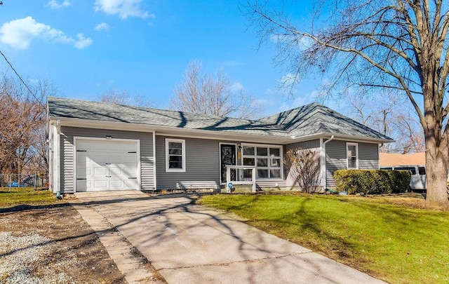 view of front of house with concrete driveway, a front lawn, roof with shingles, and an attached garage