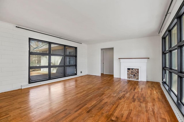 unfurnished living room with a fireplace and wood finished floors