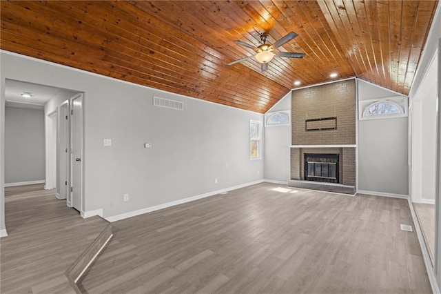 unfurnished living room featuring visible vents, a ceiling fan, wooden ceiling, lofted ceiling, and a brick fireplace
