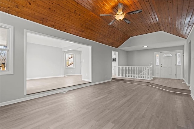unfurnished living room featuring baseboards, wood finished floors, wooden ceiling, and vaulted ceiling