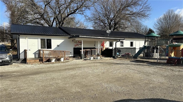 ranch-style house with a playground