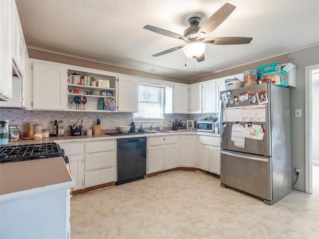 kitchen featuring appliances with stainless steel finishes, tasteful backsplash, white cabinets, ceiling fan, and a textured ceiling