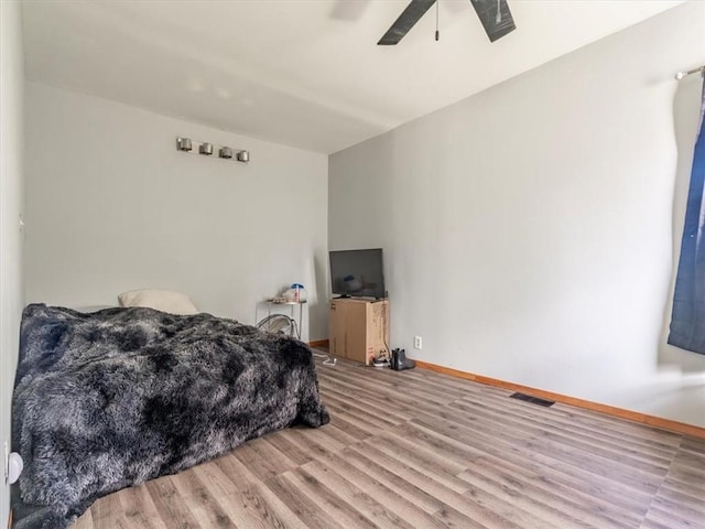 bedroom featuring light hardwood / wood-style flooring and ceiling fan