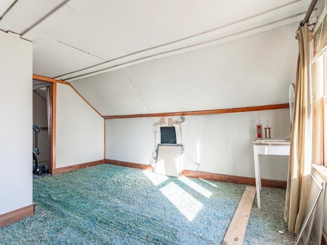 bonus room featuring lofted ceiling and carpet floors