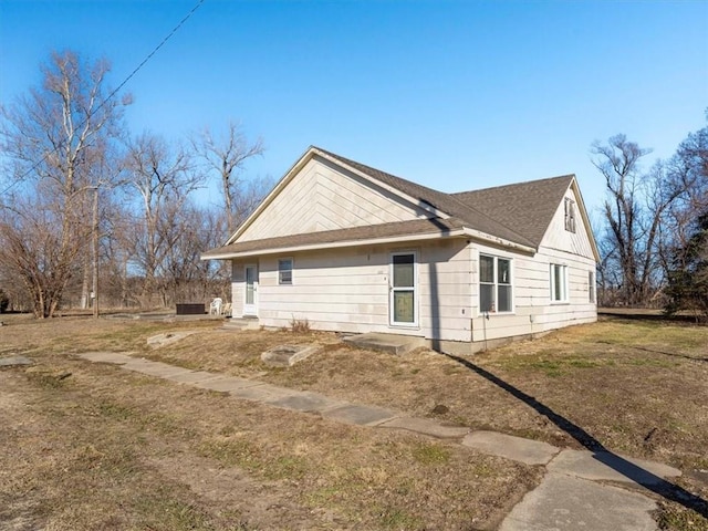 view of side of property featuring a yard