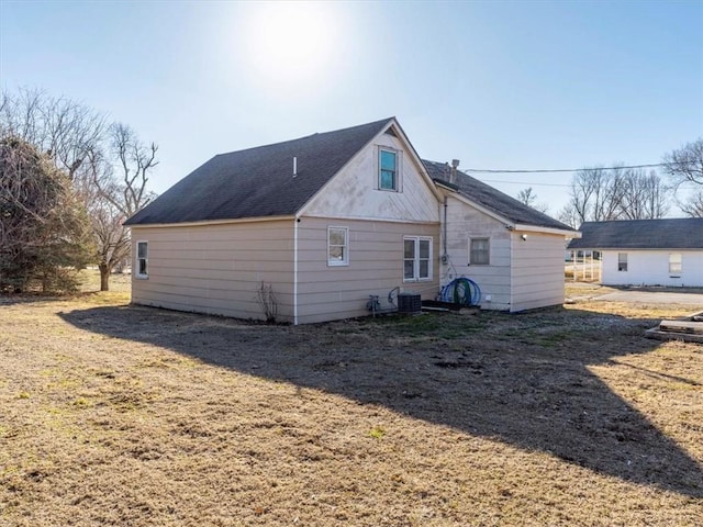 rear view of property with a yard