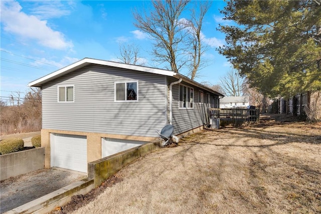 view of home's exterior featuring a garage and a deck