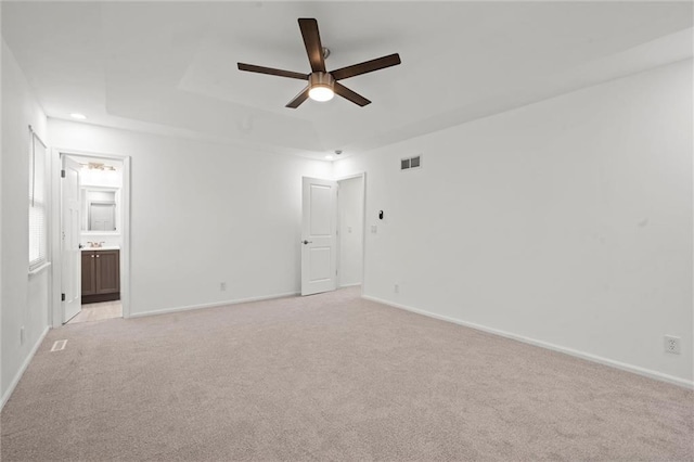 interior space with ceiling fan and a tray ceiling