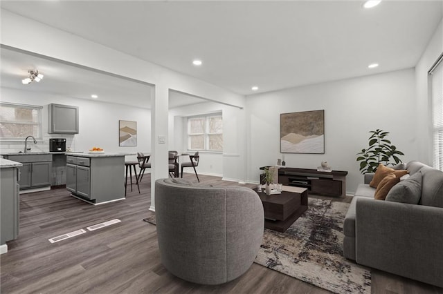 living room featuring plenty of natural light, baseboards, dark wood-type flooring, and recessed lighting