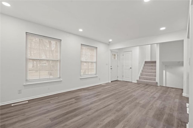 unfurnished living room featuring hardwood / wood-style floors